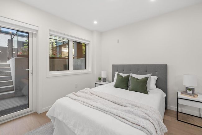Bedroom with wood finished floors and recessed lighting | Image 11
