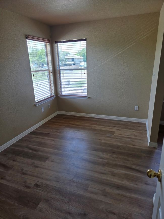 Spare room featuring dark wood-type flooring and a textured wall | Image 30