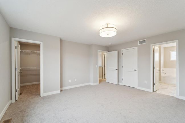 Owner's bedroom with 2 closets and niche for dresser, TV, or artwork. This is not the actual home for sale, but photos of the same floorplan. Additional options may be shown. | Image 11