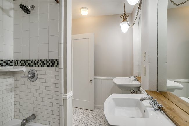 Bathroom featuring wainscoting, tile patterned floors, and bathing tub / shower combination | Image 13