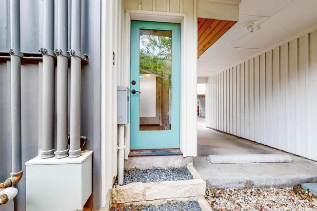 Doorway to property featuring board and batten siding | Image 26