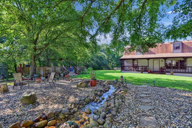 View of yard with an outdoor fire pit and fence | Image 31