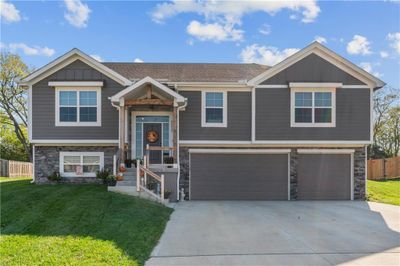 Split foyer home featuring a garage and a front yard | Image 1