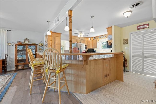 Another view of the spacious kitchen and bifold doors to right have a great pantry space with window. | Image 9