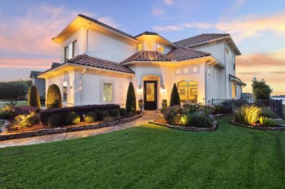 DRAMATIC FRONT ELEVATION WITH UPLIGHTING AND LUSH LANDSCAPING COMBINED WITH MEDITERRANEAN ARCHITECTURE TO CREATE A BEAUTIFUL CURB APPEAL. | Image 3