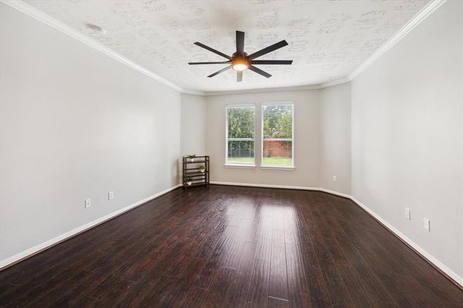 This primary bedroom accommodates easily your kingsize furniture plus a chaise, desk, armoire or exercise equipment. | Image 30
