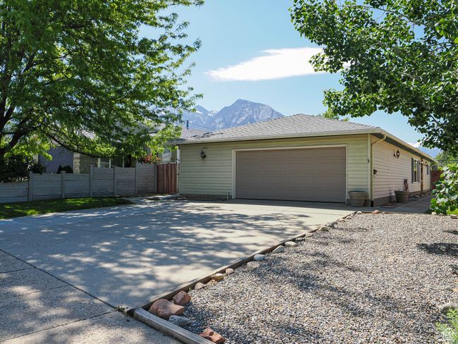 View of home's exterior with a garage, a mountain view, and driveway | Image 38