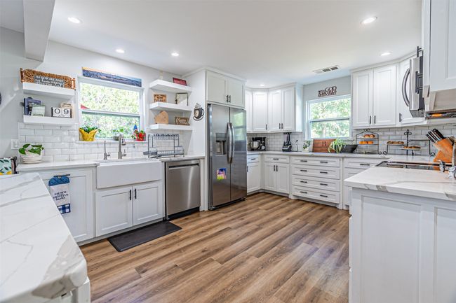 Kitchen with appliances with stainless steel finishes, open shelves, tasteful backsplash, and recessed lighting | Image 12