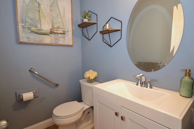 Bathroom featuring baseboards, toilet, and vanity | Image 10