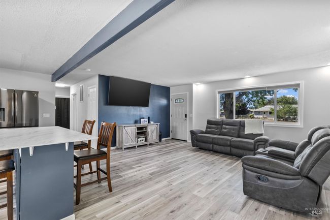 Living room with light wood-style floors and a textured ceiling | Image 9