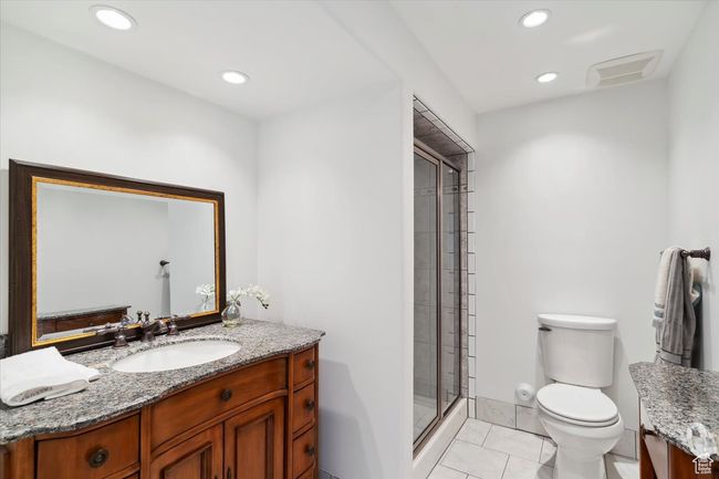 Bathroom featuring vanity, toilet, a shower stall, and recessed lighting | Image 25