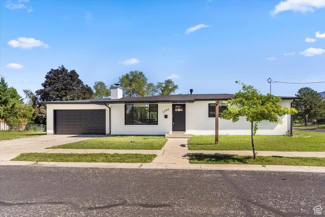 Ranch-style home featuring a chimney, driveway, and an attached garage | Image 5