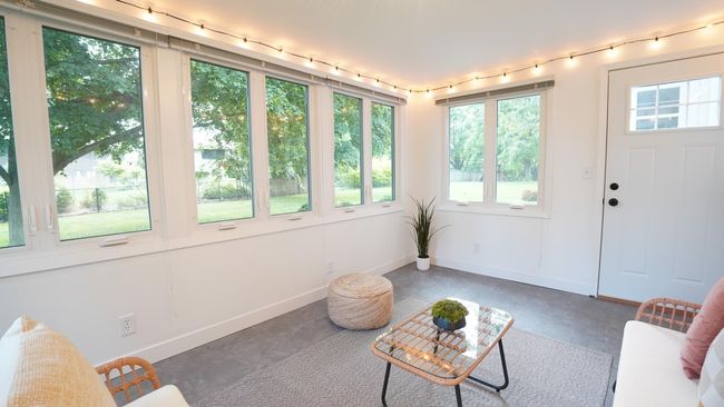 The light and bright sunroom is a versatile space that is staged as a porch but could also make for an excellent work from home office, yoga room, or artist studio. | Image 40