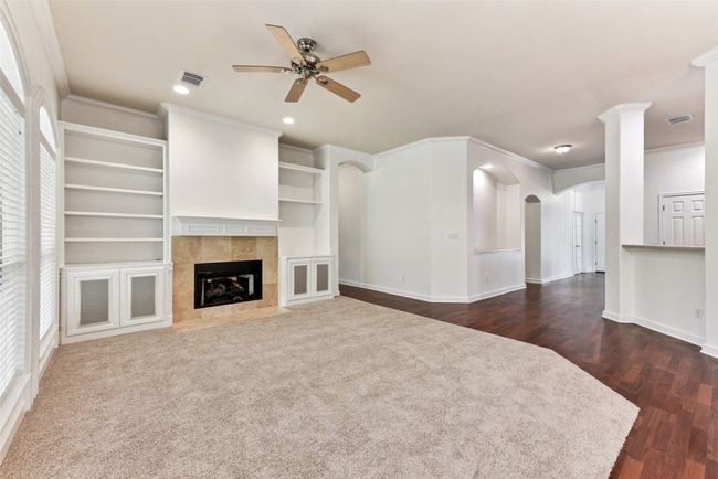 Another view of this fabulous family room with fresh paint, carpet and crown molding. | Image 23