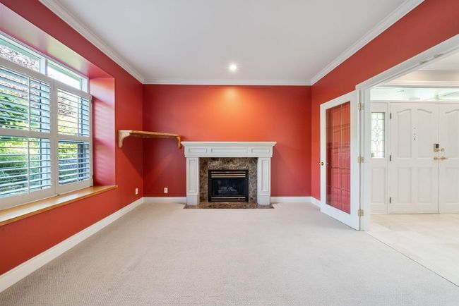 Unfurnished living room featuring crown molding, a high end fireplace, and carpet floors | Image 5