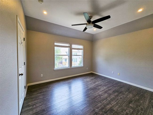 Unfurnished room with a ceiling fan, dark wood-style floors, baseboards, recessed lighting, and a textured wall | Image 22