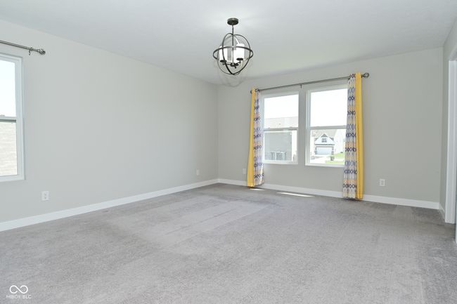 spare room with baseboards, carpet flooring, and an inviting chandelier | Image 39