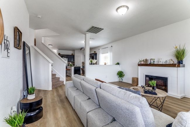 Living area featuring wood finished floors, stairway, and a fireplace | Image 10