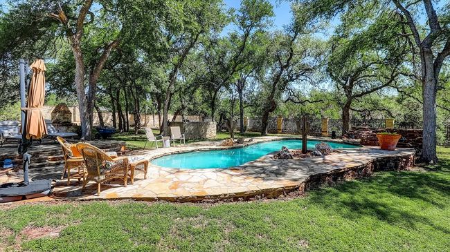View of pool with a lawn, a patio area, a fenced in pool, and a fenced backyard | Image 37