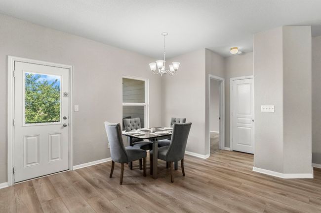 Kitchen eating area. Door to back yard. Door on right goes to the primary bedroom. | Image 6