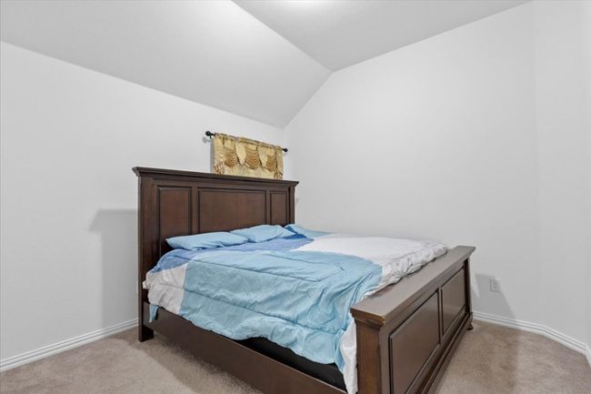 Bedroom featuring lofted ceiling, baseboards, and light carpet | Image 20