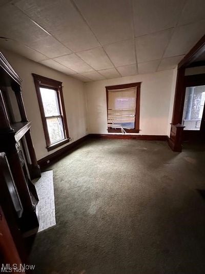 Carpeted spare room with a paneled ceiling | Image 2