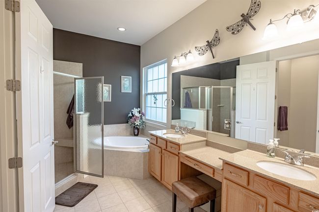 Bathroom featuring plus walk in shower, vanity, and tile patterned flooring | Image 28
