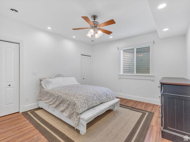 Bedroom with recessed lighting, light wood-type flooring, baseboards, and ceiling fan | Image 27