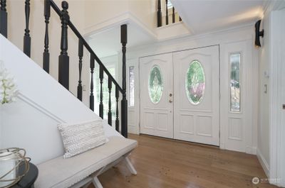 Step into a grand entrance leading to a fully refreshed home, featuring new carpeting, fresh paint, and updated lighting throughout. | Image 2