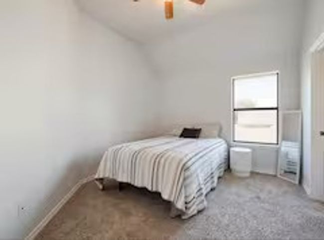 Carpeted bedroom featuring a ceiling fan | Image 14