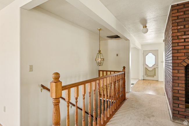 Hall featuring an upstairs landing, carpet flooring, and a textured ceiling | Image 26