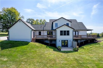 Rear view of house with a yard and a wooden deck | Image 3