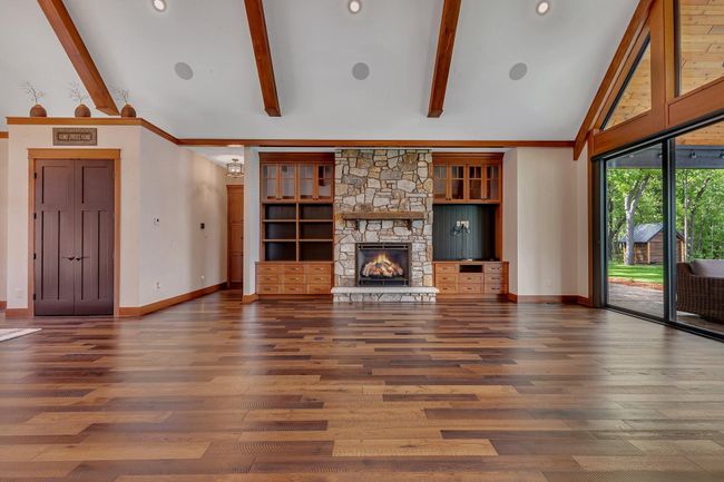 Elegant stone gas fireplace with custom built-ins, adding both warmth and style to the space. | Image 33