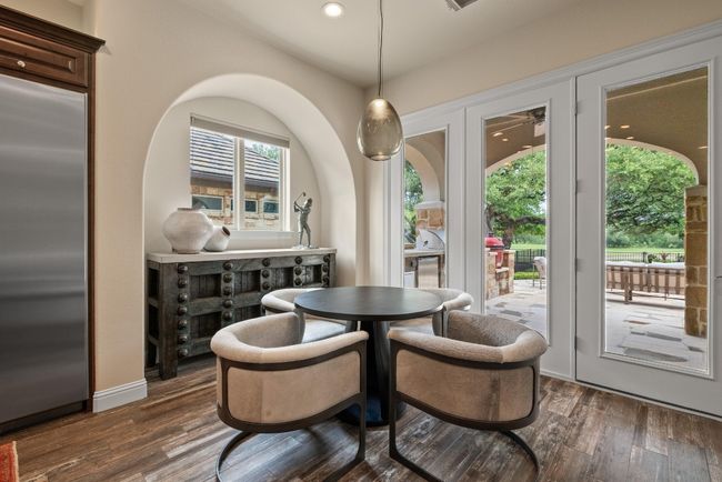 Dining space with dark wood-style flooring and recessed lighting | Image 15