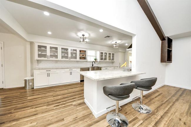 Breakfast bar bridges kitchen and living spaces—perfect for casual meals and staying connected. | Image 8