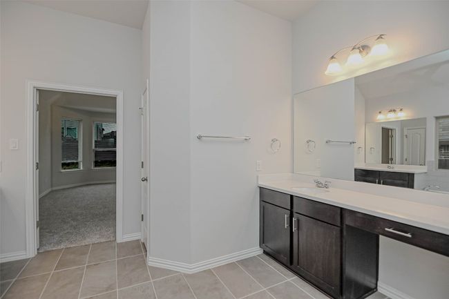 Full bathroom featuring baseboards, tile patterned floors, and vanity | Image 19