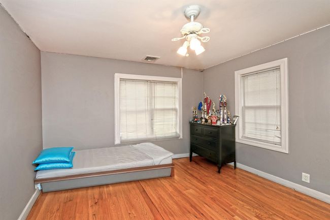 Unfurnished bedroom featuring baseboards, visible vents, and wood finished floors | Image 17