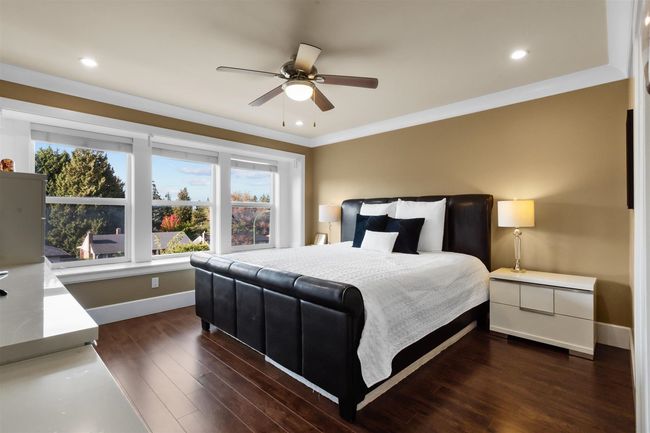 Bedroom featuring baseboards, dark wood-style flooring, ornamental molding, recessed lighting, and a ceiling fan | Image 17