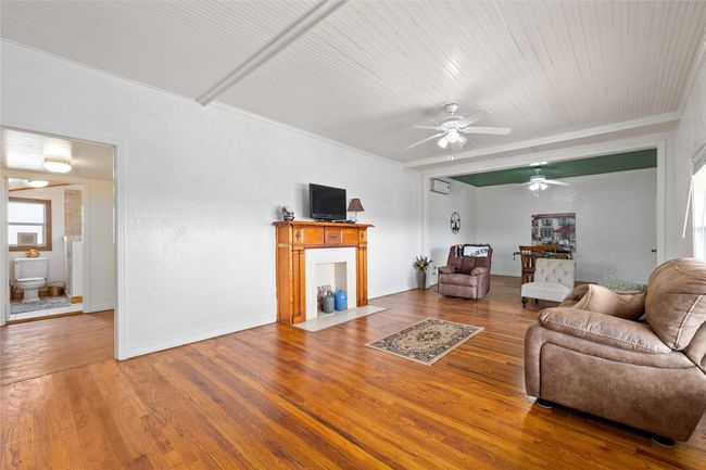 Living room featuring ceiling fan, wood finished floors, and crown molding | Image 9