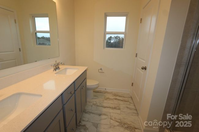 Primary en-suite bathroom with dual vanity and closet | Image 18