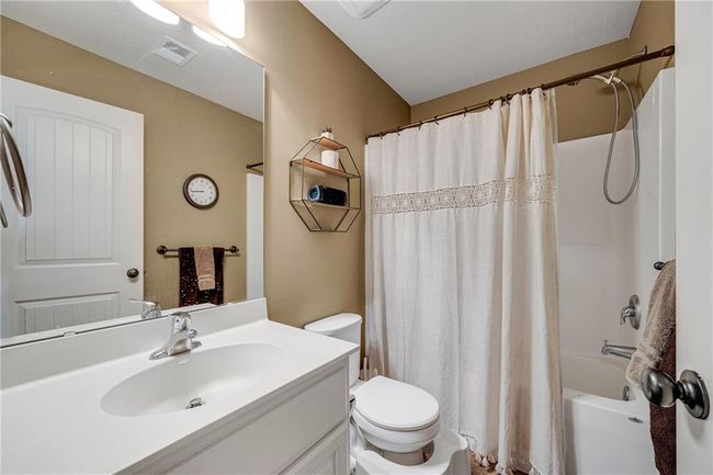 Upper level bathrom with shower over tub, tile flooring and a single vanity. | Image 38