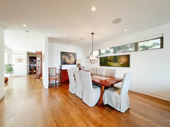 Dining room featuring light wood-style flooring, recessed lighting, baseboards, and a chandelier | Image 6