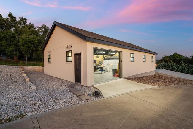 Property exterior at dusk featuring stucco siding and a patio area | Image 34