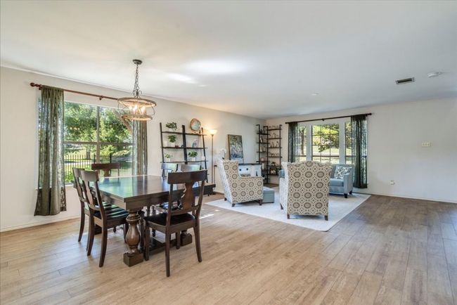Formal dining area is located adjacent to the formal living area as you enter the home. | Image 10