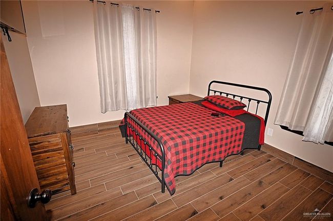 Bedroom with hardwood / wood-style floors | Image 21