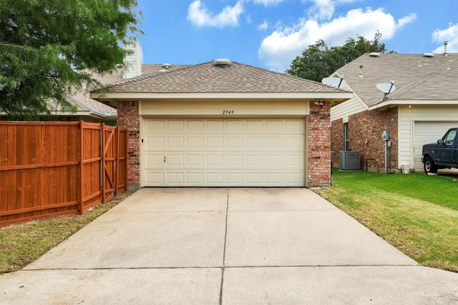View of front of property featuring brick siding and a garage | Image 30