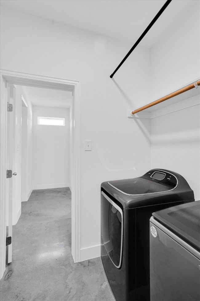 Empty room with finished concrete flooring, ceiling fan, and baseboards | Image 20