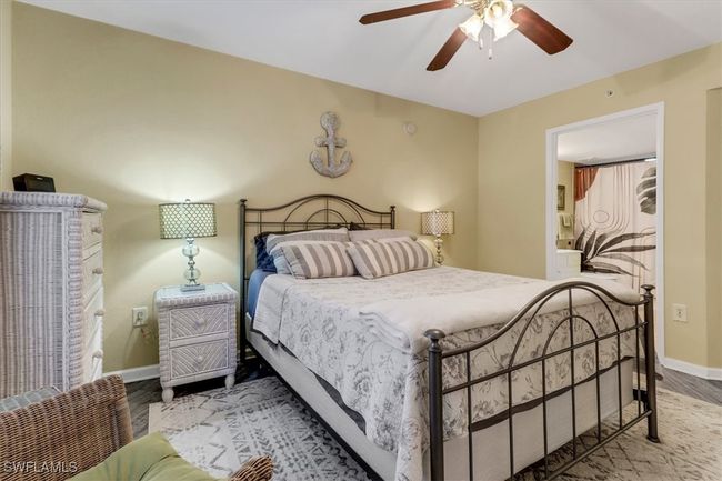 Bedroom with wood finished floors and ceiling fan | Image 16