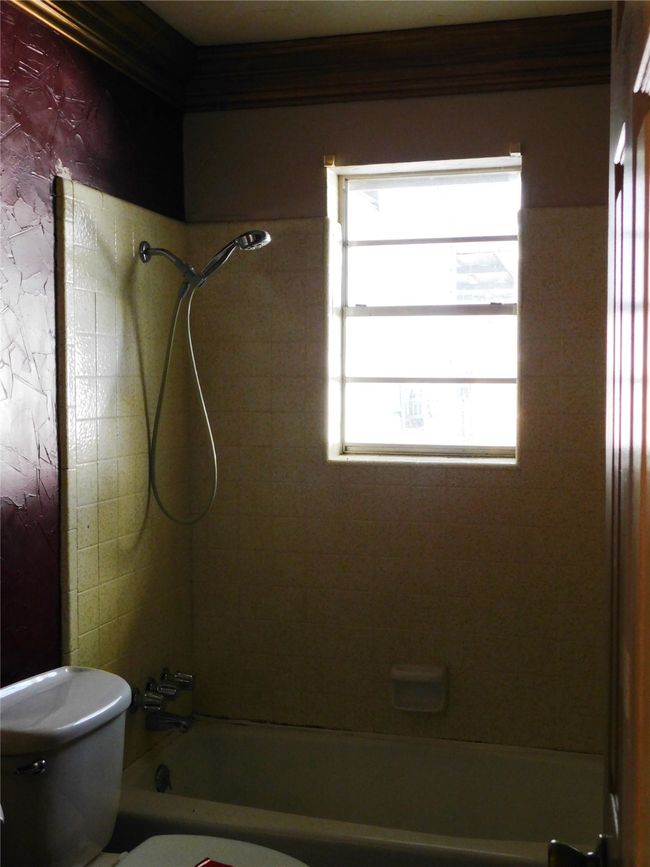 Bathroom featuring toilet and tiled shower / bath | Image 11