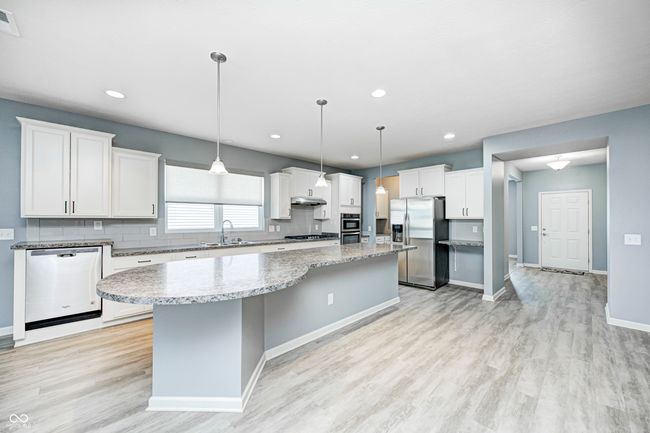 Large open kitchen and island. Additional eating area to the right. | Image 6